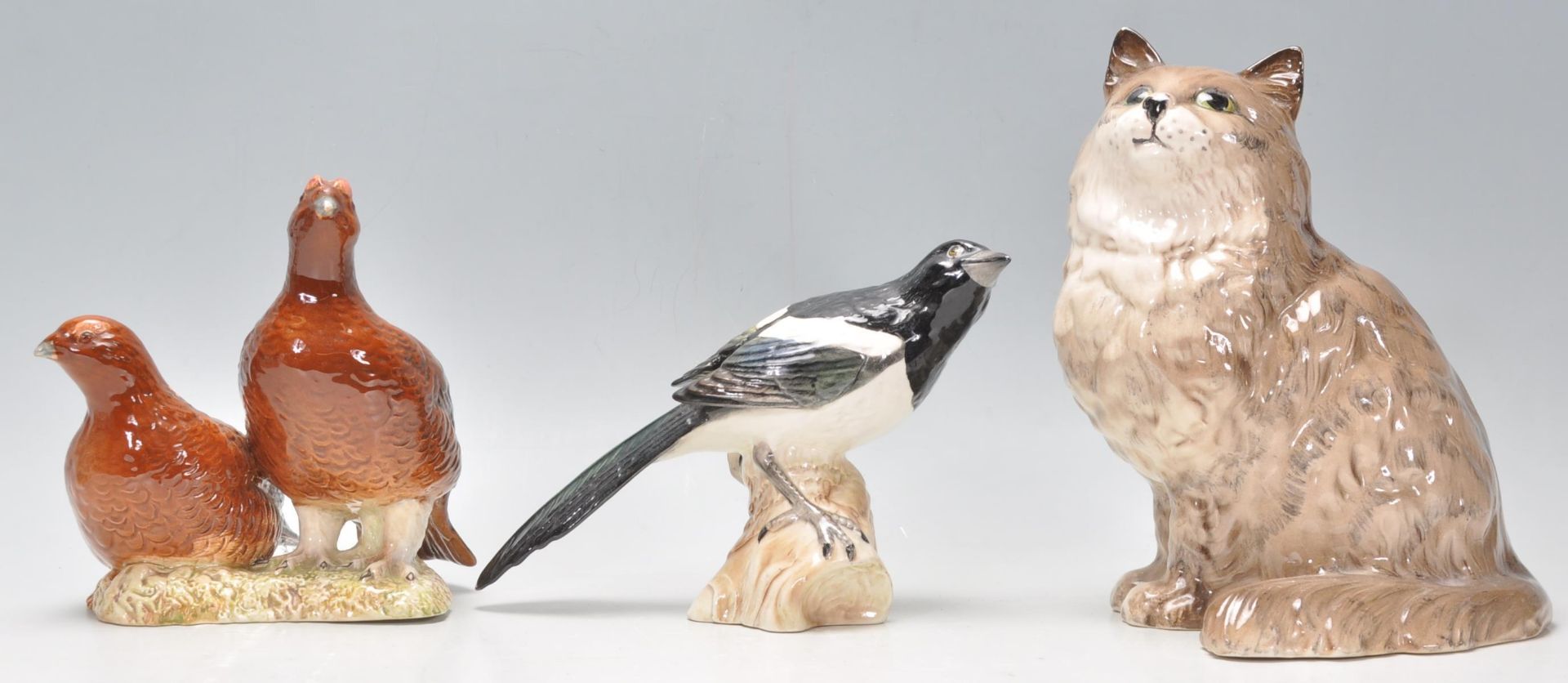 A collection of 20th century animal figurines to include a Beswick 2063 group of partridges together