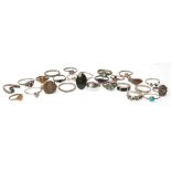 A collection of twenty six silver rings to include an abalone shell ring, a tigers eye cabochon