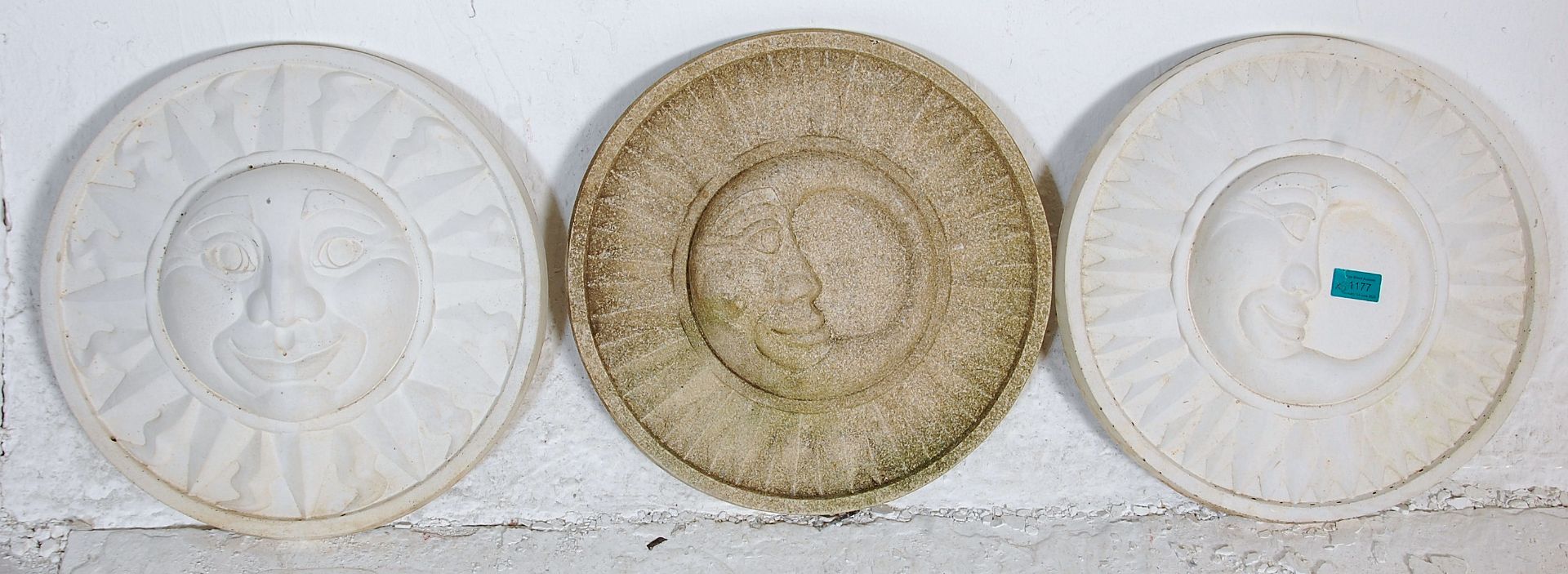 A group of three 20th Century antique syle garden wall plaques of round form each having moulded sun