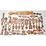 A collection of 24 wooden hand carved Welsh love spoons. To include, pierced heart and cross,