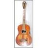 A 20th Century Columbia Junior six string acoustic guitar having a rustic varnished body with