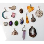 A group of fifteen silver pendants to include a Delft windmill pendant, an amber drop pendant with