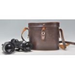 A pair of early 20th century leather cased Ross of London binoculars. Set within original brown