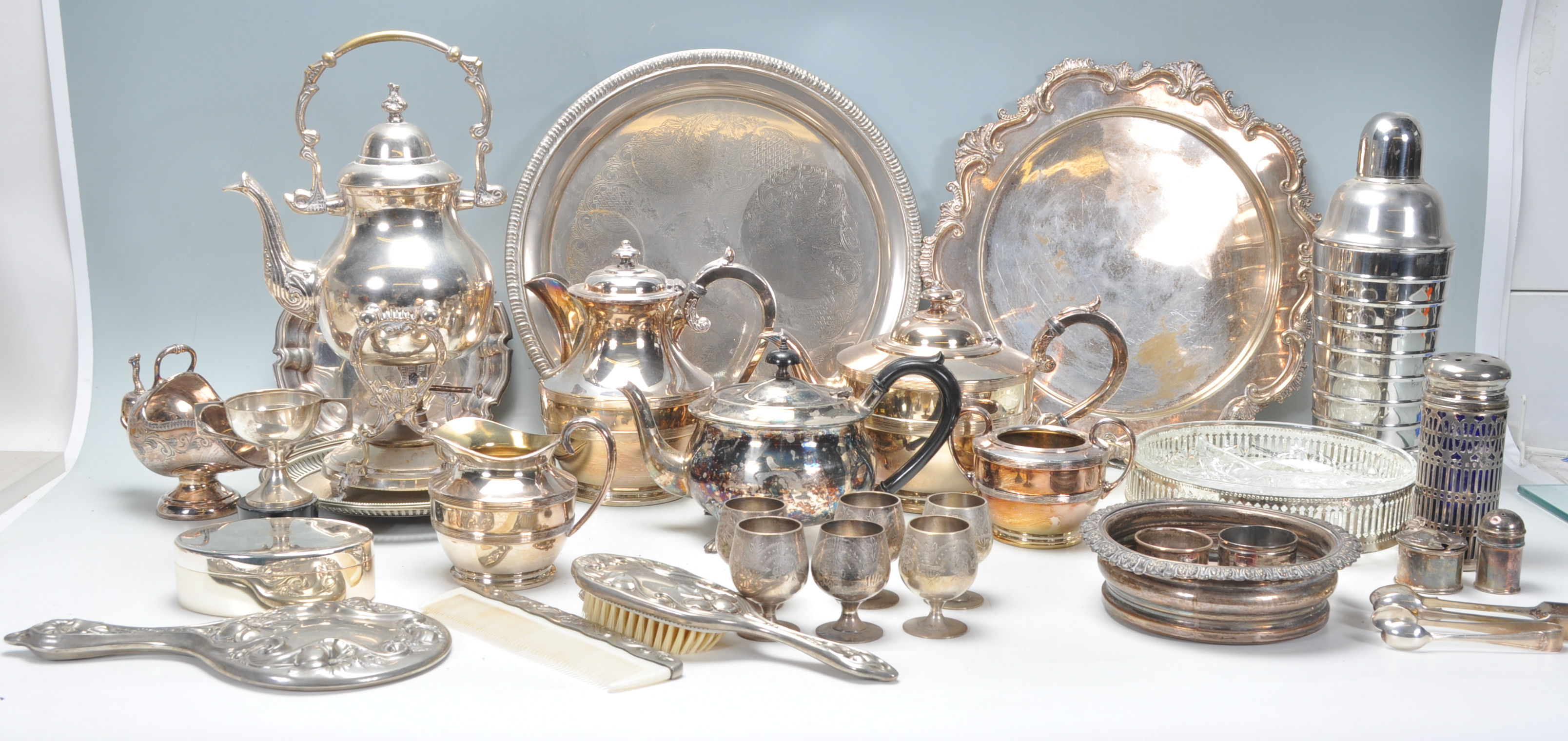 A large collection of silver plated wares to include coffee pot, teapot, condiments, dressing