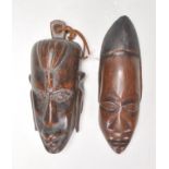 Two carved wooden African tribal wall hanging masks. 23cm long.