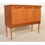 A retro mid 20th Century G Plan teak wood sideboard credenza having three cupboard doors below a