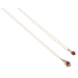 Two 9ct gold pendant necklaces with one set with a heart shaped red stone on a long 9ct gold