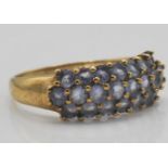 A hallmarked 9ct gold and amethyst cluster band ring. Total weight 2.5g / Size P.