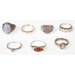 A collection of silver rings to include cabochon set single stone rub over setting, amber ring.