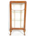A good 1930's Art Deco walnut display cabinet having a single glazed door with glass panel sides and