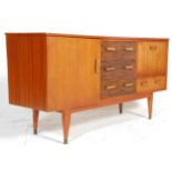 A retro mid 20th Century teak wood sideboard credenza having a central bank of three drawers flanked