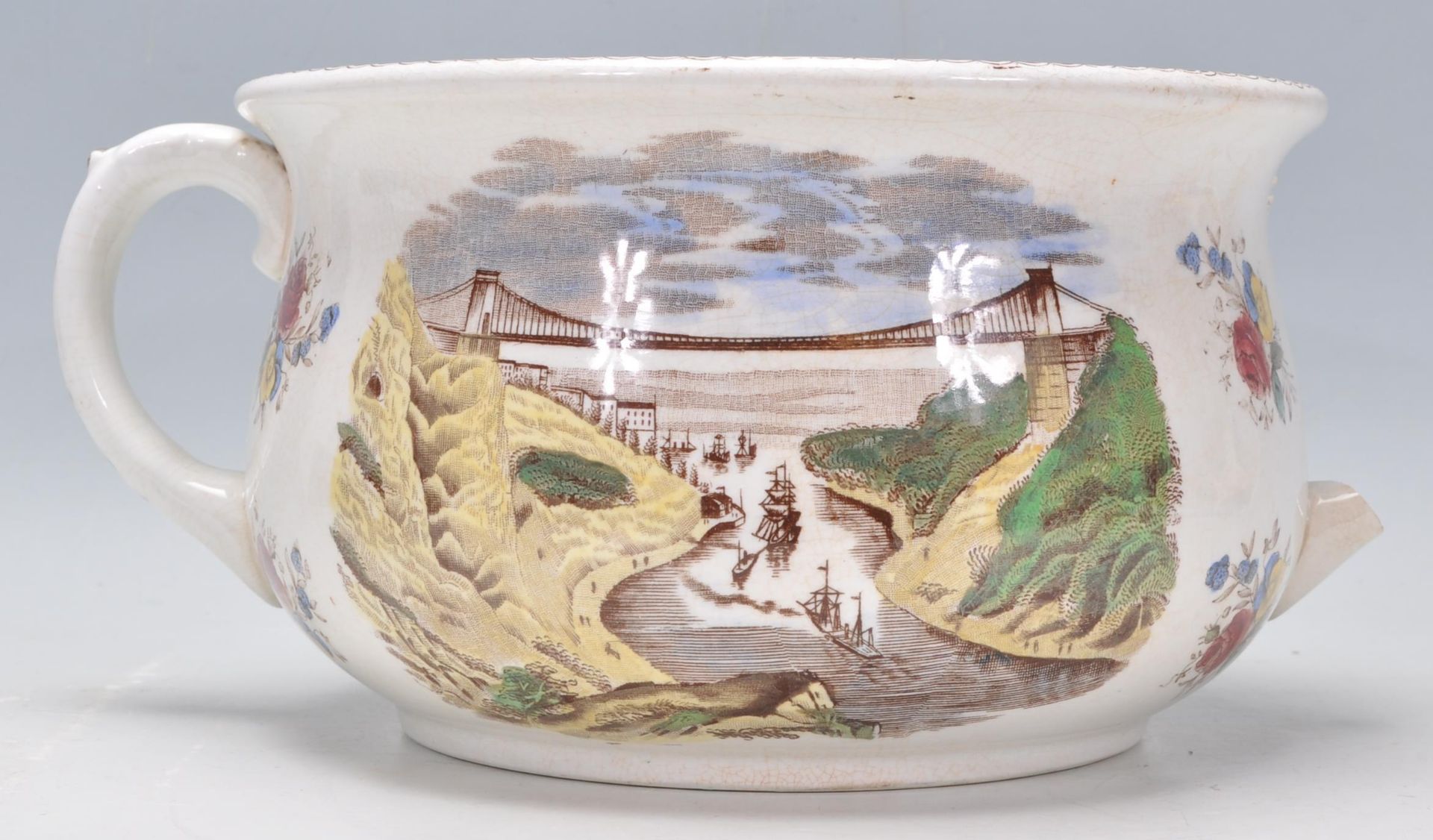 A 19th Century Victorian humorous pottery chamber pot. The interior decorated with two figures in