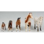 A  collection of Beswick horse porcelain figurines to include a rare spotted Appaloosa black and