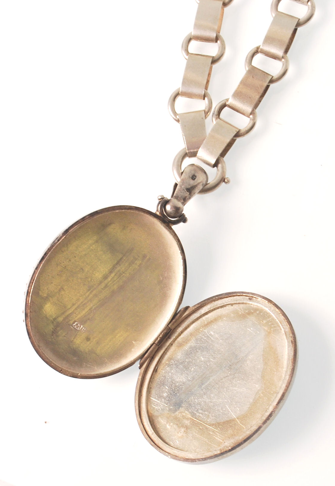 A hallmarked 19th century Victorian silver oval locket pendant being strung upon a book chain. The - Image 5 of 6