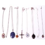 A selection of silver pendant necklaces to include a crucifix pendant set with a black stone