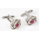 A pair of stamped 925 silver gentleman's cufflinks having knot design heads set with round cut