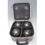 A group of four vintage lawn bowls within their original fitted case. Bowls marked Hensel Official