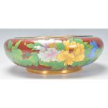 A 20th century Chinese enamel decorated brass fruit bowl. The bowl with stunning ochre red ground