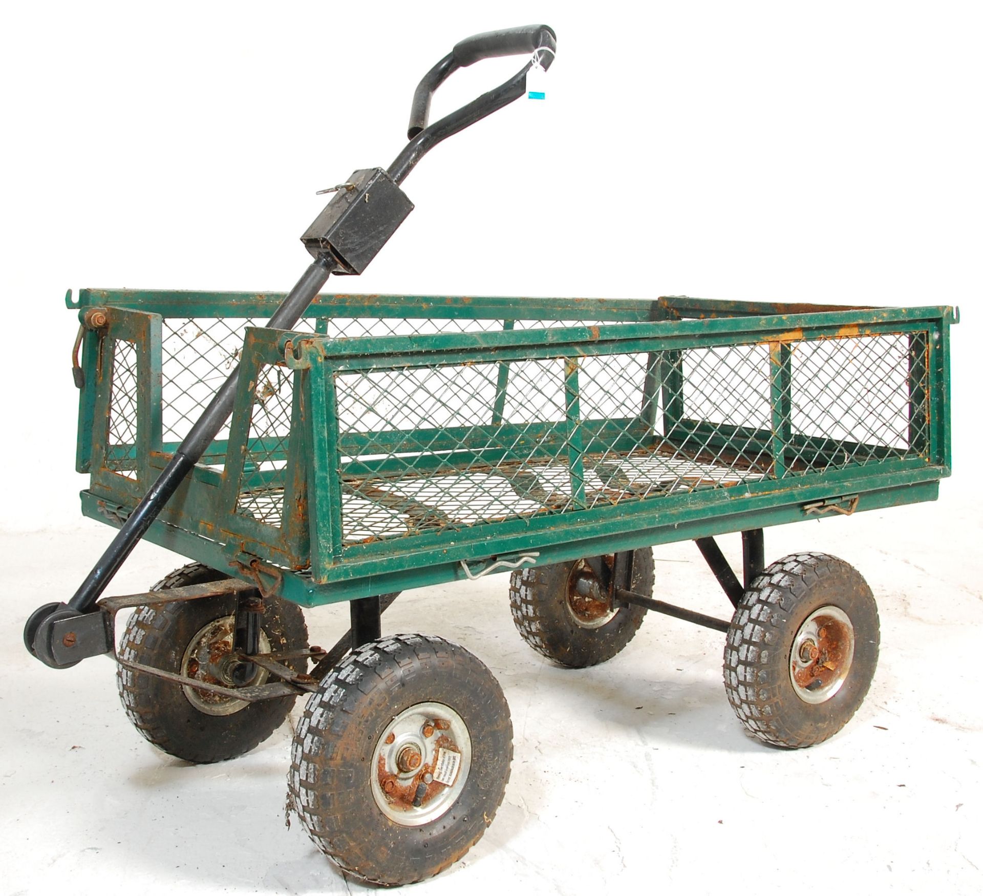 A metal four wheel pull along trolley finished in green with fold down sides. 85cm x 105cm x 55cm.