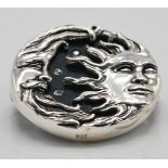 A stamped 925 silver brooch in the form of the sun and moon set with a round onyx panel and CZ