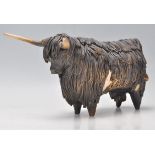 A vintage retro Devon studio pottery ceramic Highland cow / bull with encrusted details and tapering