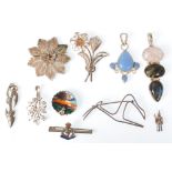 A collection of silver brooches and pendants to include a silver Royal Army Medical Corps brooch,