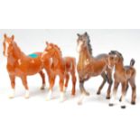 A  collection of 4 Beswick horse porcelain figurines to include 2 light brown mares, each with white