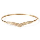 A hallmarked 9ct gold and alexandrite wishbone bangle / bracelet. The bangle with wishbone design