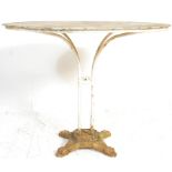 A vintage 20th Century rustic French metal garden furniture table having a round top raised on