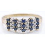 A 9ct hallmarked gold sapphire and diamond stepped cluster ring. The ring having alternating
