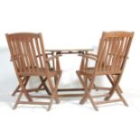 A small teak garden table together with a set of four teak folding armchairs and one other smaller