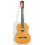 A vintage Ramon made six string acoustic guitar having inlaid decoration. Paper label to inner for