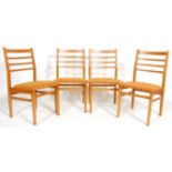 A set of four vintage retro dining chairs having teak wood frames with ladder backs, stuffed seats
