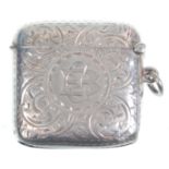 An early 20th Century silver hallmarked vesta of square form having engraved scrolled foliate
