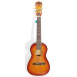 A vintage Audition made acoustic six string guitar having a reinforced steel neck, original tag