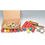 A collection of vintage 20th Century coloured snooker balls together with wooden triangle and cue