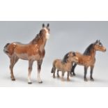 A group of three Beswick horses all painted brown