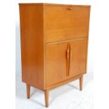 A retro mid century vintage teak wood cocktail cabinet. The cabinet having a metamorphic action drop