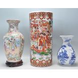 A collection of Chinese porcelain to include a large famille rose vase on a wooden socle plinth, a
