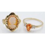 A hallmarked 9ct yellow gold ladies ring set with a fire opal droplet flanked by white stones to the