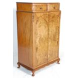 A vintage 20th Century Art Deco walnut tallboy raised on stub cabriole legs with twin serpentine