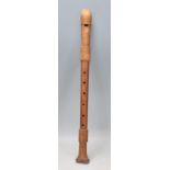 A vintage early to mid 20th Century fruitwood three section alto recorder musical instrument.
