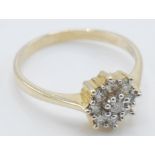 A 9ct gold ladies ring set with a cluster of nine round cut diamonds to the head. Ring marked 375.