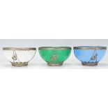 A group of three early 20th Century Chinese brass mounted multi coloured glass bowls having white