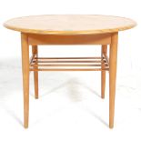A small vintage retro 20th Century round coffee table / side table raised on tapering teak