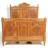 A good antique 19th century French walnut double bed having raised head and footboard with panel