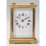 A good quality early 20th century brass cased carriage clock having enamel dial with roman numeral