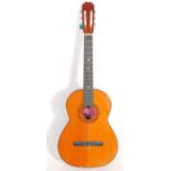 A BM Ronda Spanish made six string acoustic guitar having inlaid decoration. Paper label to inner
