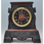 A early 20th Century Art Deco 1920's Egyptian Revival black slate and red marble mantel clock. The