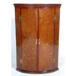 A late 18th century George III solid country oak bow fronted corner cabinet. The cabinet with twin